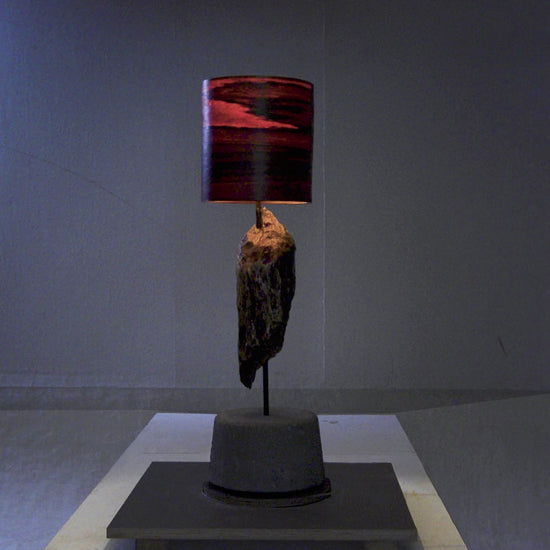 Driftwood Light Sculpture LO06 – Treibholz Lampe mit Echtholz Furnier & Beton-Sockel, beleuchtet im dunklen Raum mit Lichtreflexionen.